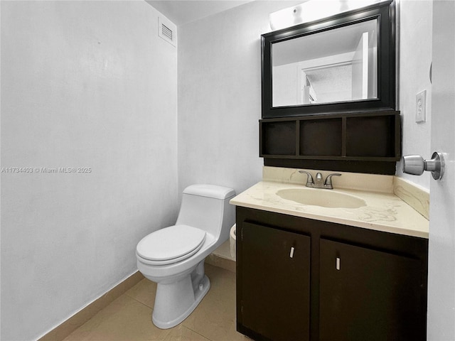 bathroom with vanity, tile patterned floors, and toilet