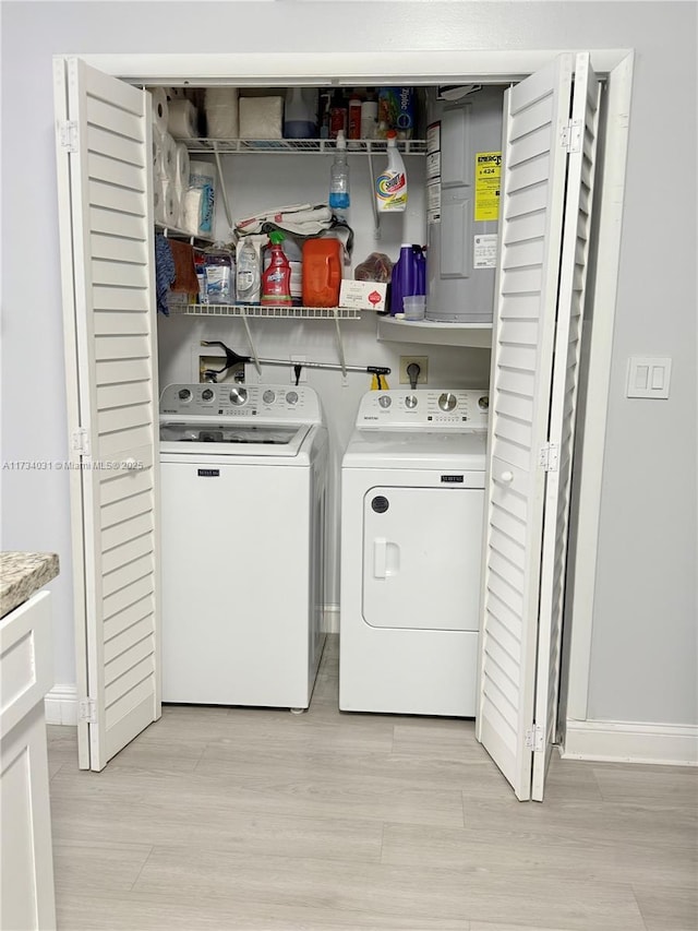 clothes washing area featuring independent washer and dryer and light wood-type flooring