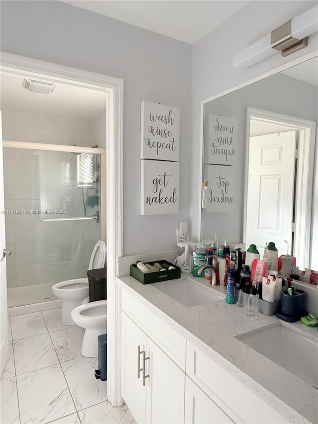 bathroom with a bidet, vanity, toilet, and walk in shower