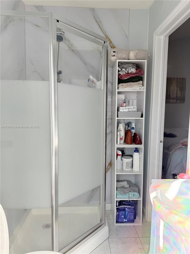 bathroom with walk in shower and tile patterned floors