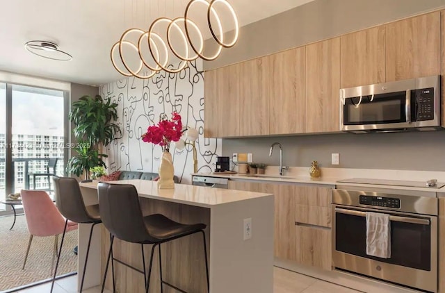 kitchen featuring floor to ceiling windows, appliances with stainless steel finishes, sink, and light brown cabinets