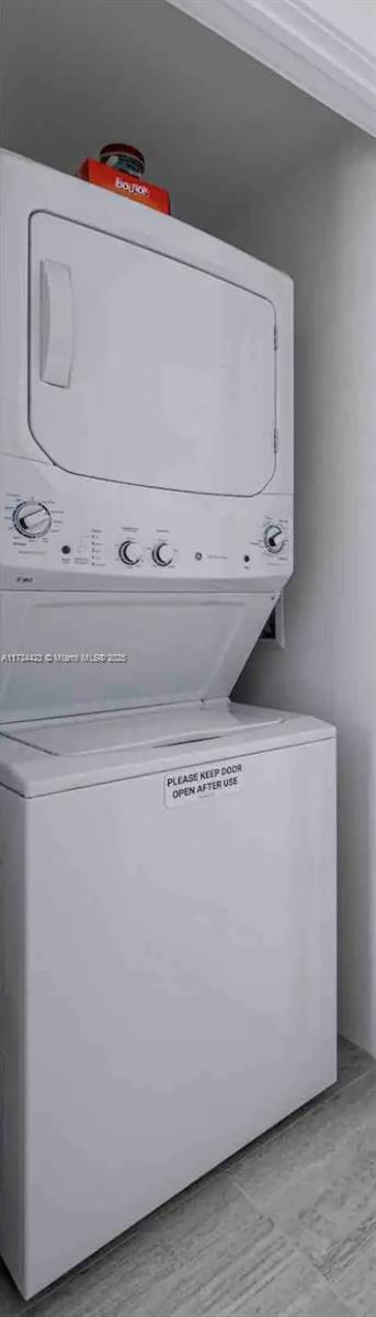 laundry area featuring stacked washer / dryer