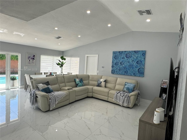 living room featuring visible vents, plenty of natural light, and lofted ceiling