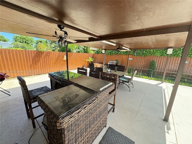 view of patio / terrace featuring outdoor dining area, fence, and ceiling fan