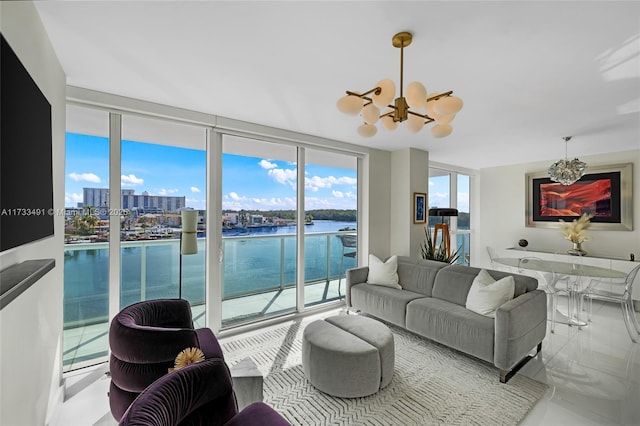 living room featuring expansive windows, a water view, and an inviting chandelier