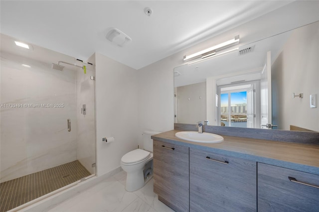 bathroom with vanity, an enclosed shower, and toilet