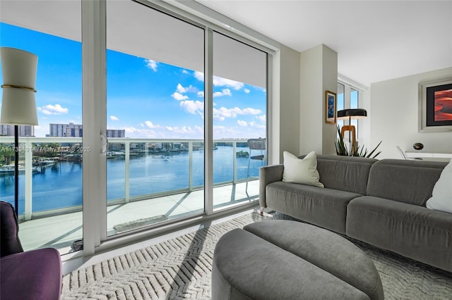 living room with a wall of windows and a water view