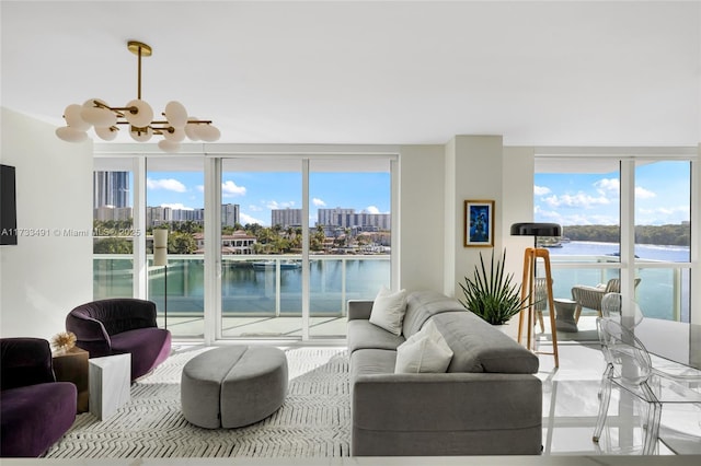 living room featuring a water view, floor to ceiling windows, and a notable chandelier