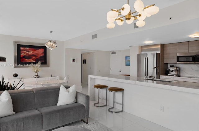 living room featuring an inviting chandelier and sink