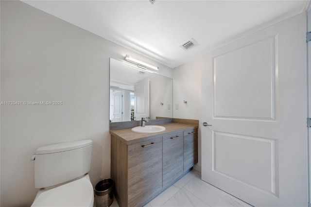 bathroom featuring vanity and toilet