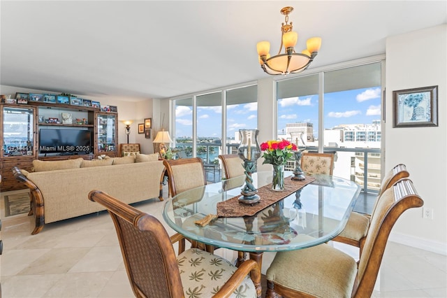 dining room with expansive windows and a chandelier