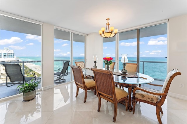 6365 Collins Ave Unit 1901, Miami Beach, FL 33141 - dining space with expansive windows, a chandelier, a water view, and light tile patterned floors