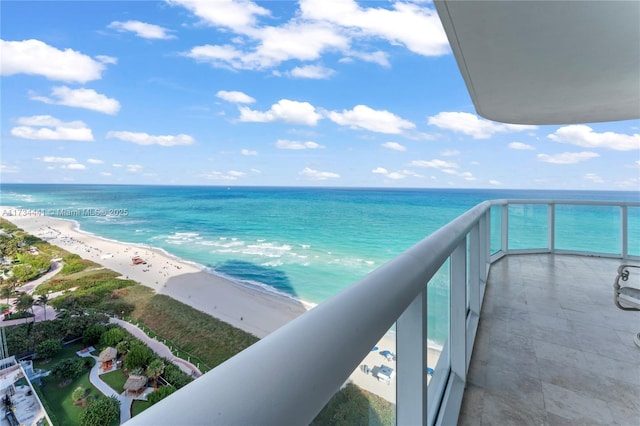 balcony with a water view and a beach view