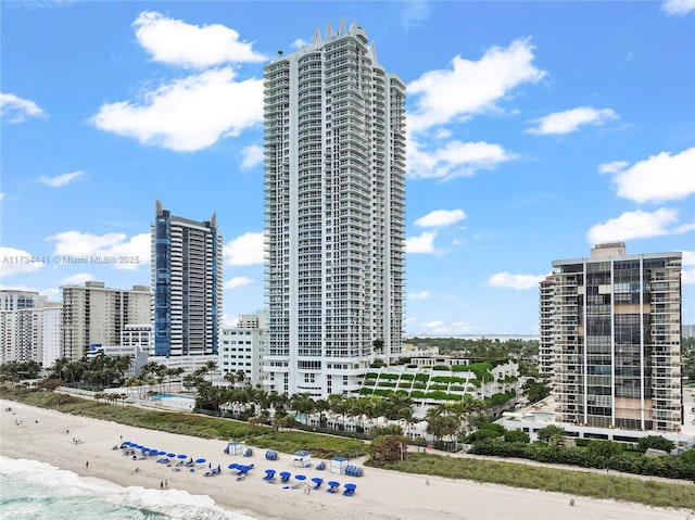 view of property with a beach view and a water view