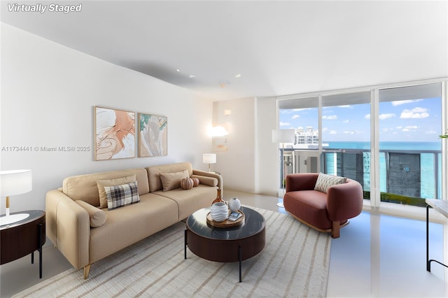 living room with a water view and expansive windows