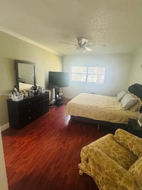 bedroom featuring dark wood-style floors, crown molding, a ceiling fan, and a textured ceiling