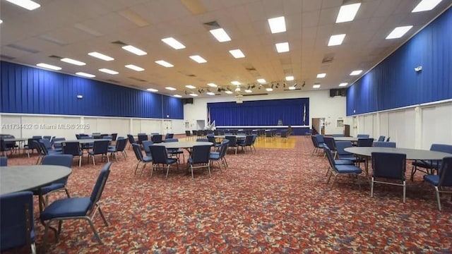 interior space with carpet and a paneled ceiling
