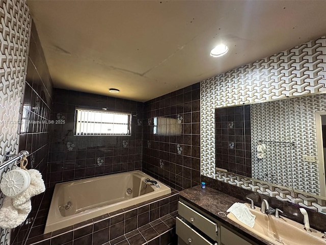 bathroom featuring vanity, tiled shower / bath, and tile walls