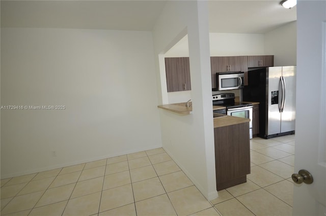 kitchen with light tile patterned floors and appliances with stainless steel finishes