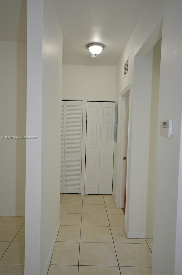 hallway featuring light tile patterned floors