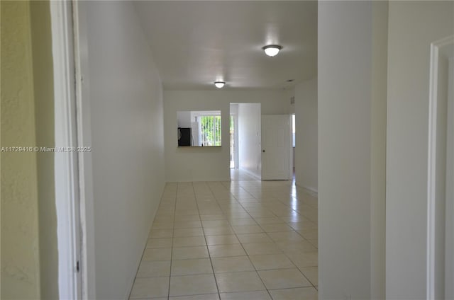 corridor with light tile patterned flooring