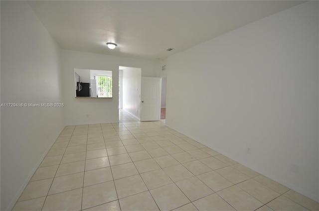 spare room with light tile patterned floors