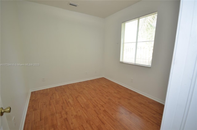 unfurnished room with wood-type flooring and plenty of natural light