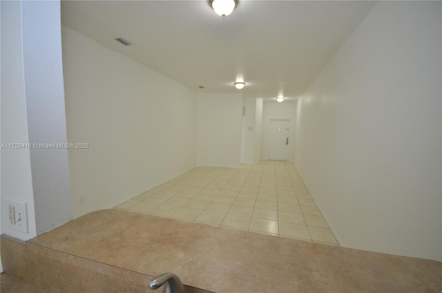 unfurnished room with light tile patterned floors