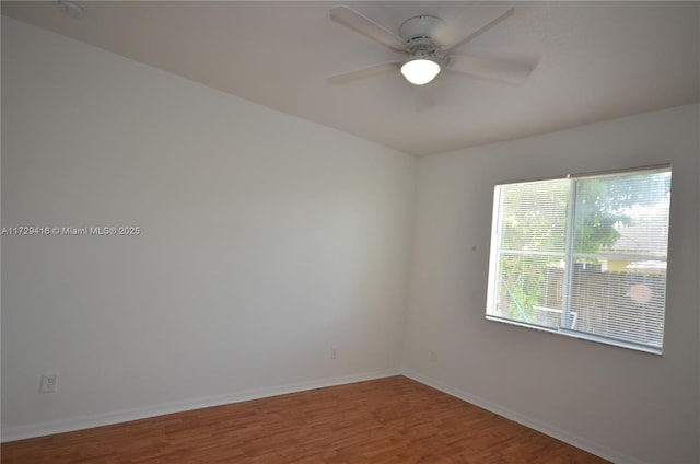 empty room featuring hardwood / wood-style flooring and ceiling fan