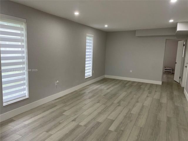 unfurnished room with light wood-type flooring