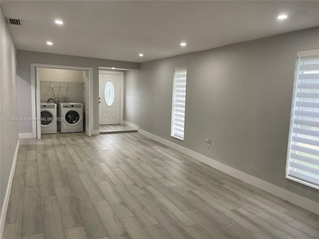 foyer with separate washer and dryer and light wood-type flooring