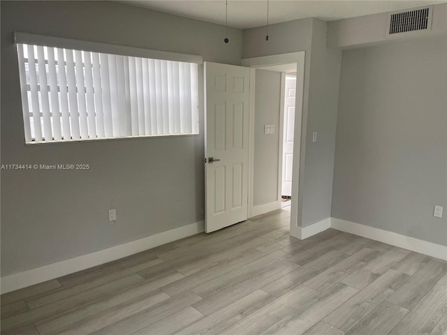 unfurnished room featuring light hardwood / wood-style flooring