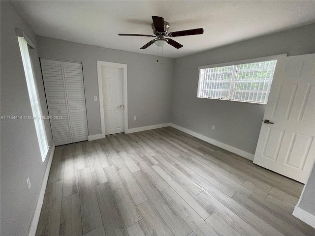 unfurnished bedroom featuring ceiling fan and light hardwood / wood-style floors