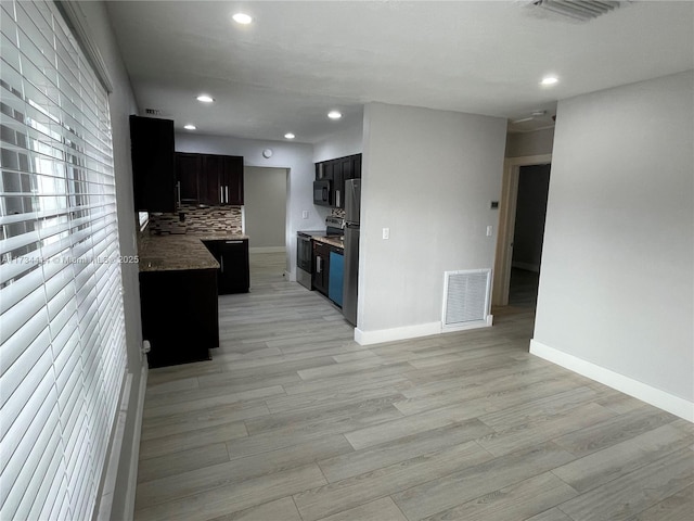 kitchen featuring tasteful backsplash, electric range, and light wood-type flooring