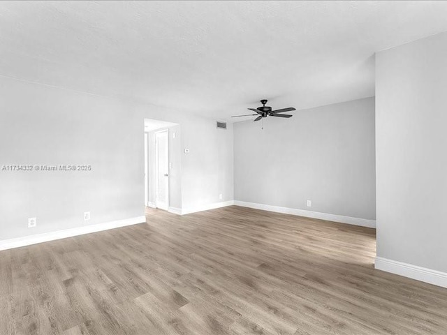 spare room with ceiling fan and light hardwood / wood-style flooring