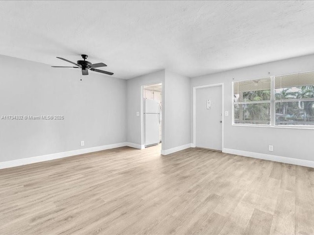 interior space with ceiling fan and light hardwood / wood-style flooring