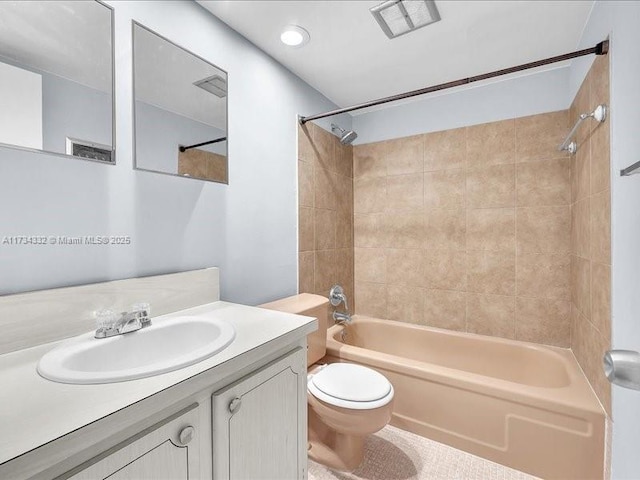 full bathroom featuring tiled shower / bath combo, vanity, and toilet