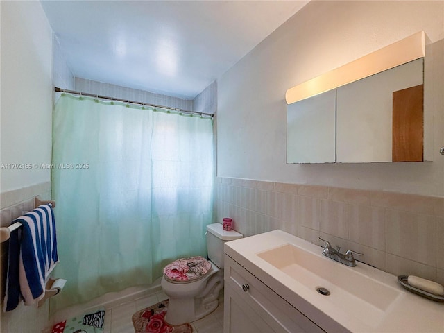 full bathroom featuring tile walls, tile patterned flooring, vanity, shower / tub combo, and toilet