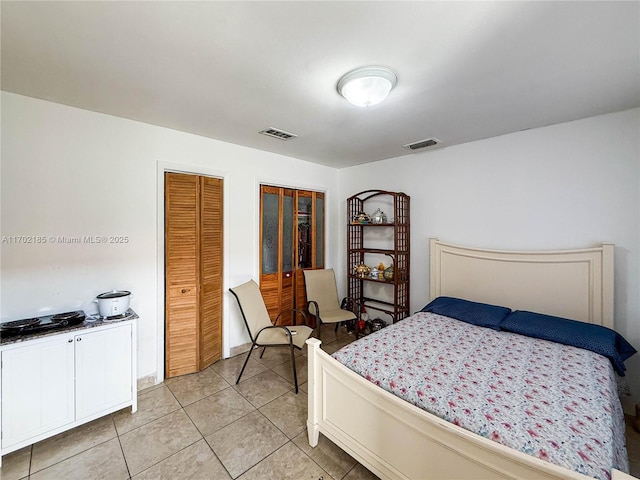 bedroom with light tile patterned floors