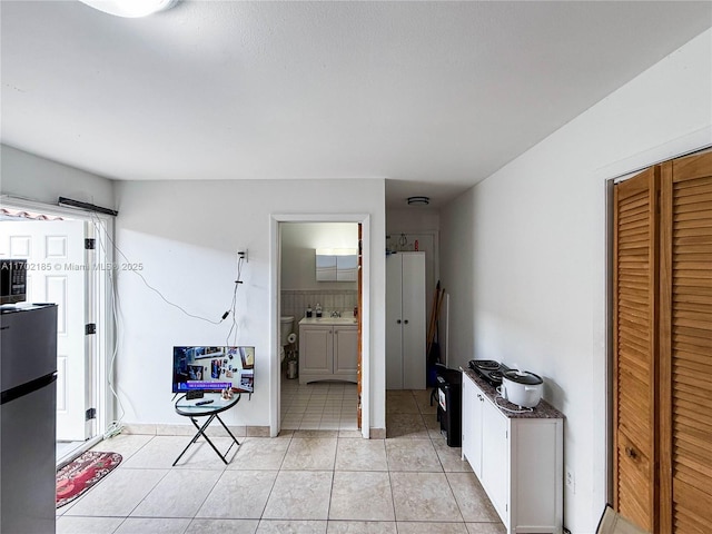 interior space featuring sink and tile patterned flooring