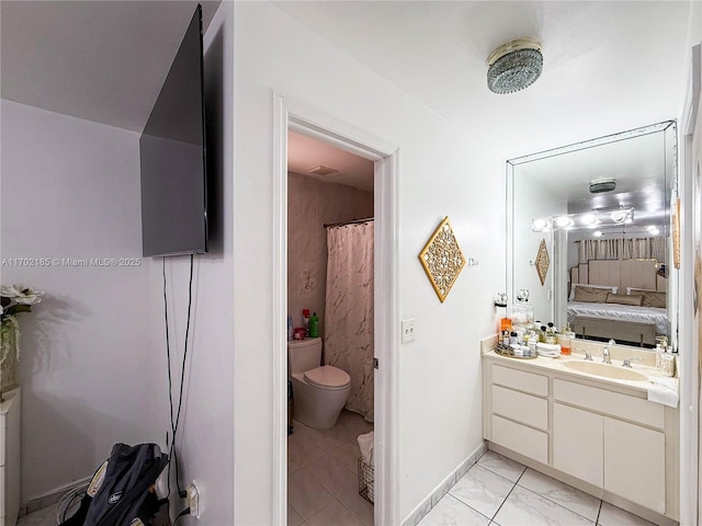 bathroom featuring vanity and toilet