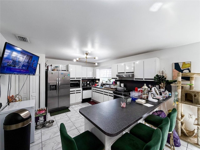 kitchen featuring white cabinetry, sink, backsplash, kitchen peninsula, and stainless steel refrigerator with ice dispenser