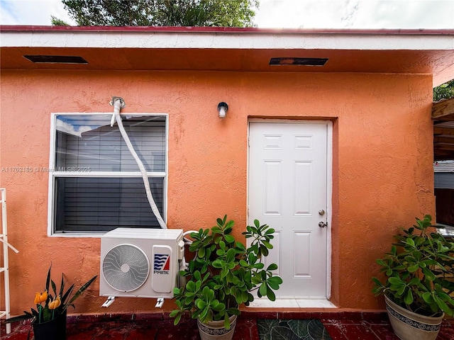 view of exterior entry with ac unit