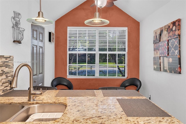 dining space with lofted ceiling and sink