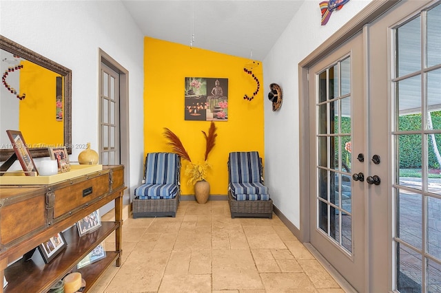 living area featuring french doors and lofted ceiling