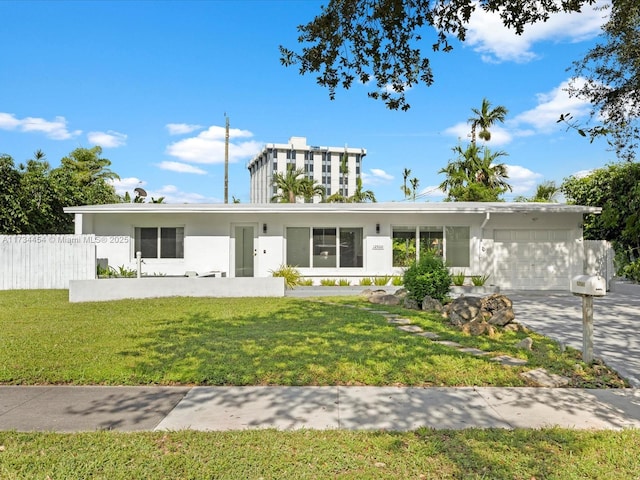 view of front of house featuring a garage and a front lawn