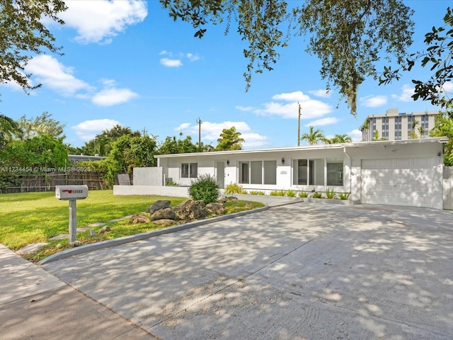 ranch-style house featuring a garage and a front yard