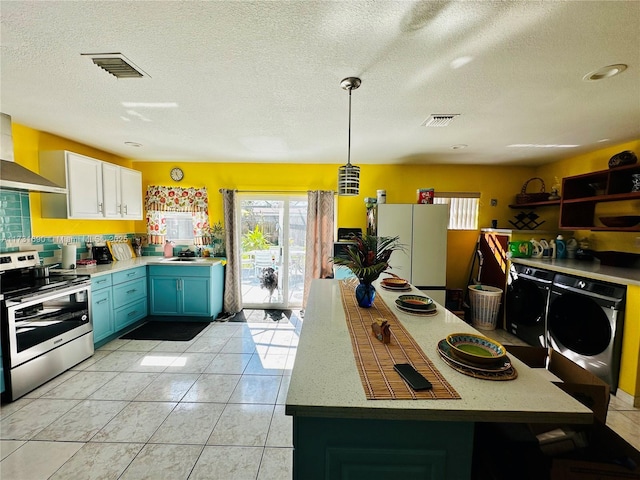 kitchen featuring white cabinetry, blue cabinets, decorative light fixtures, stainless steel range with electric cooktop, and white fridge