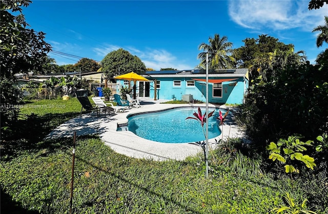 view of swimming pool featuring a yard and a patio