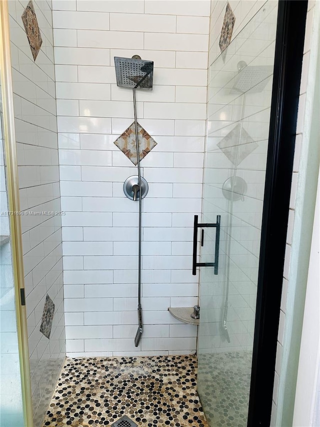 bathroom featuring a shower with door